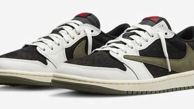 Side view of white, black, and green Jordan sneakers.